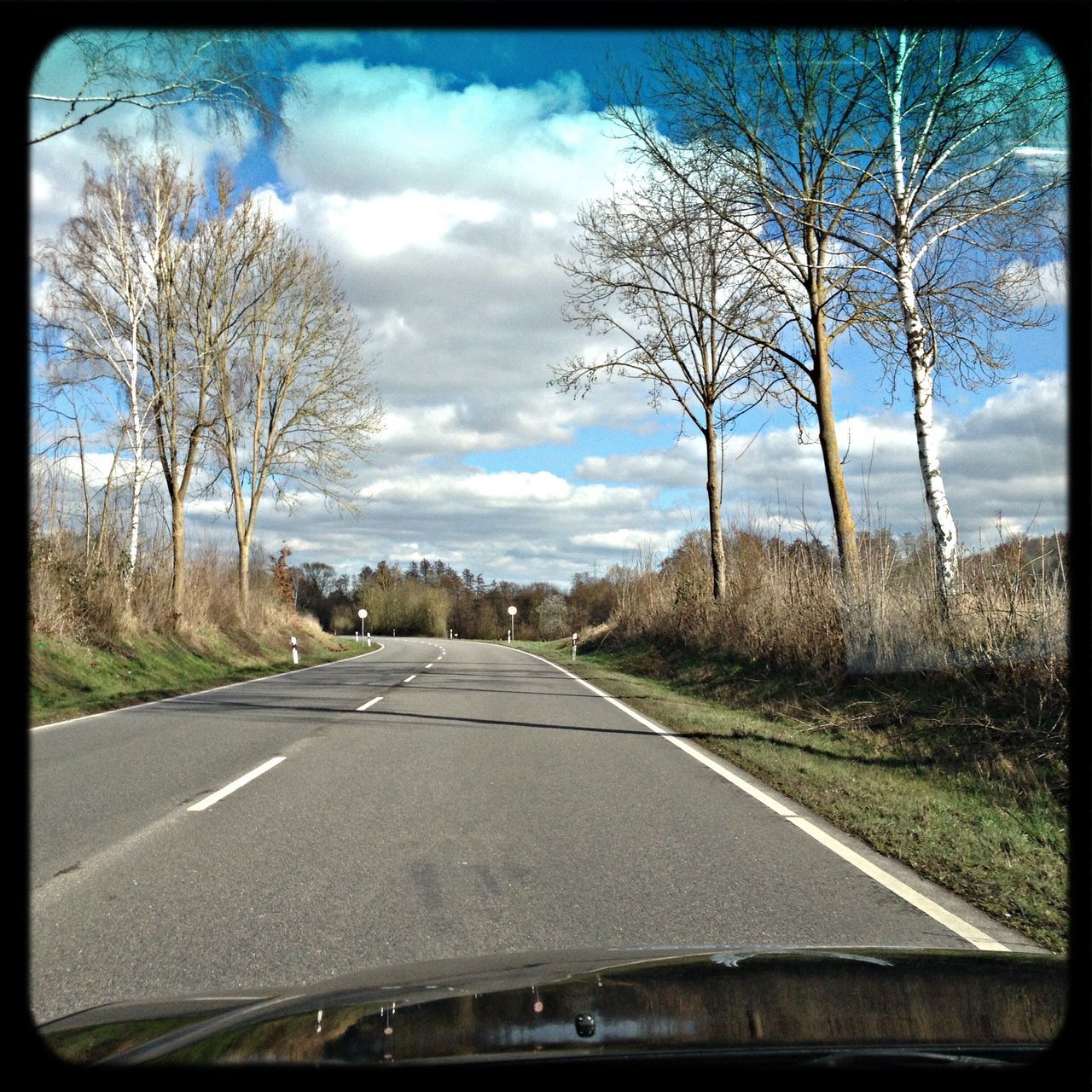 transportation, the way forward, tree, road, bare tree, sky, diminishing perspective, cloud - sky, vanishing point, country road, road marking, cloud, transfer print, empty, cloudy, landscape, tranquility, empty road, car, auto post production filter