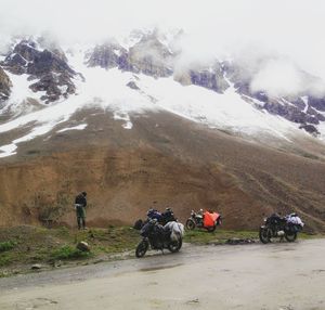 People riding bicycles on snow covered landscape