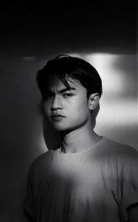 Portrait of young man against white background