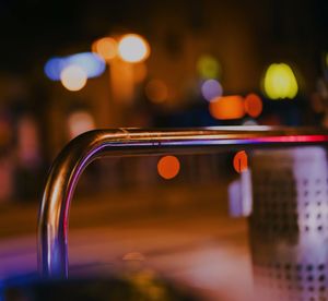 Close-up of illuminated mobile phone in city at night