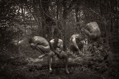 Multiple image of naked man sitting on fallen tree in forest
