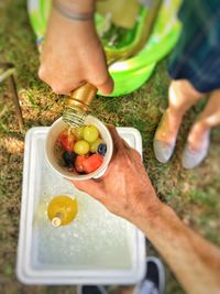 High angle view of hand holding grapes