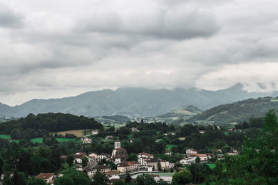 High angle view of houses against cloudy sky