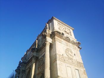 Low angle view of historical building against blue sky