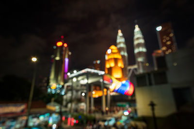 Low angle view of illuminated street light against buildings at night