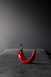 Close-up of red chili pepper against black background