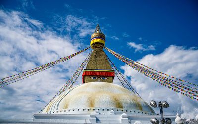 Low angle view of temple building against cloudy sky