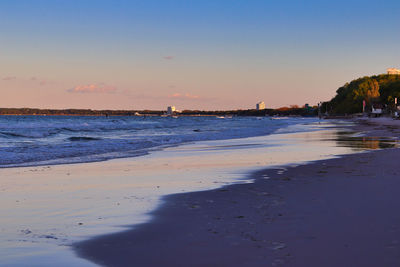 Scenic view of beach against sky during sunset