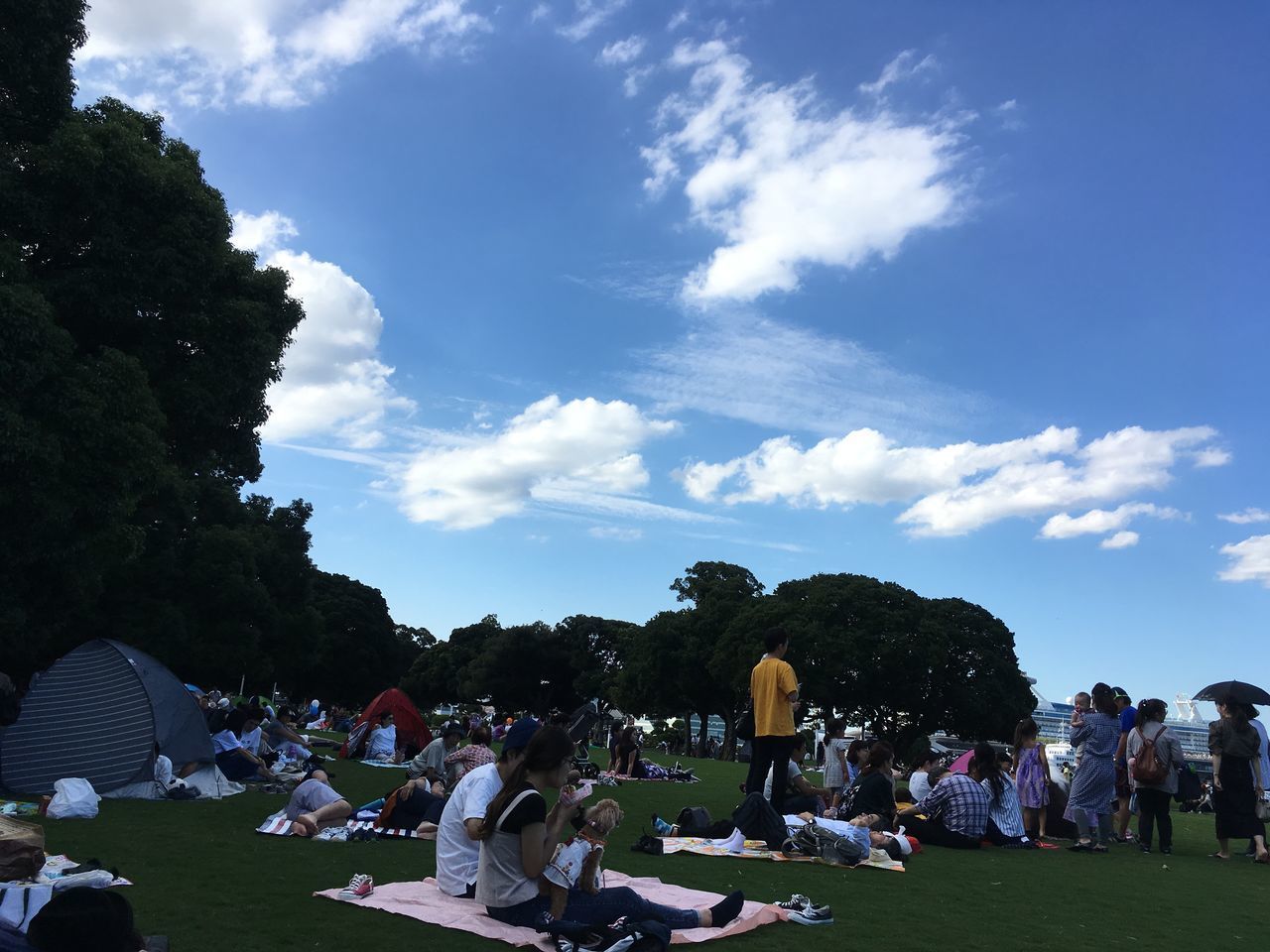 CROWD AT PARK AGAINST SKY