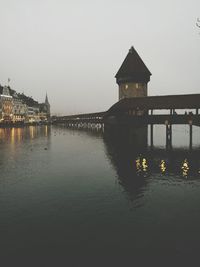 Reflection of built structure in water against sky