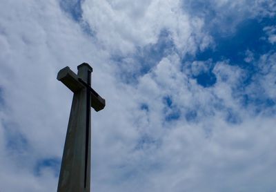 Low angle view of telephone pole against sky