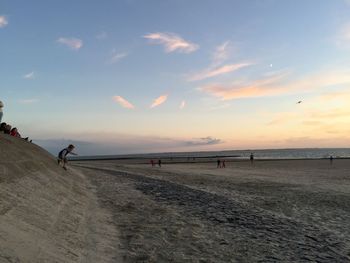 Scenic view of beach against sky during sunset