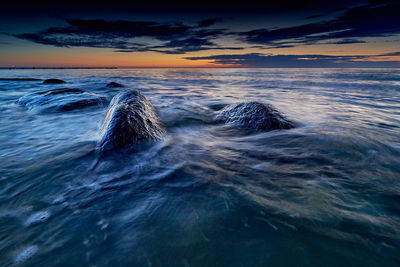 Scenic view of sea against sky at sunset