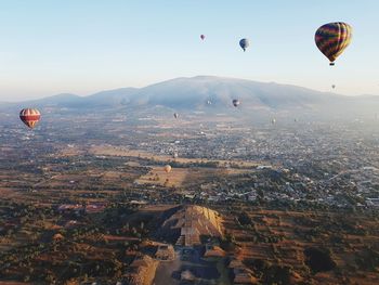 Aerial view of hot air balloons flying in city