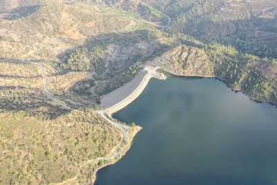 High angle view of dam and lake flowing through land lefkara 