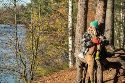 Rear view of woman standing in forest