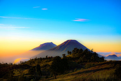 Scenic view of snowcapped mountains against sky during sunset