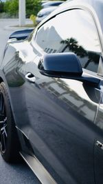 Close-up of side-view mirror of car on road