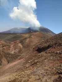 Scenic view of volcano's erruption against sky