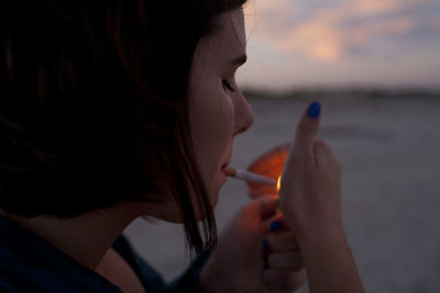 Young woman lighting a cigarette