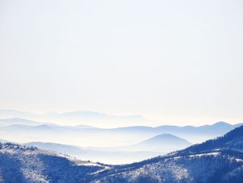 Scenic view of snowcapped mountains against clear sky