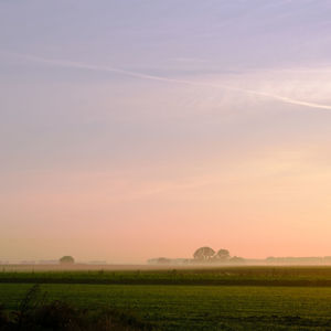 Scenic view of field against sky during sunset