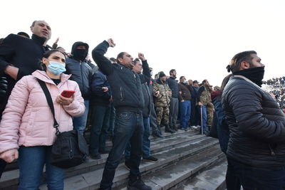 Group of people standing against clear sky