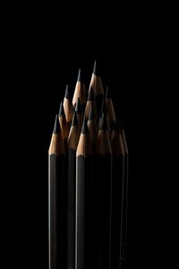 Close-up of colored pencils against black background