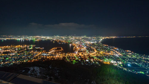 High angle view of illuminated buildings in city at night