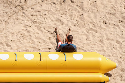 High angle view of boy sitting on beach