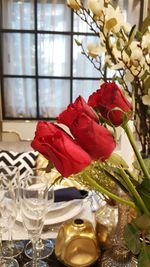 Close-up of red rose in vase on table