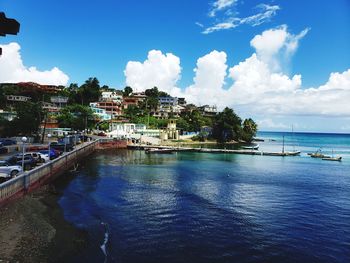 Scenic view of sea and buildings against sky