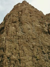 Low angle view of rock formation against sky