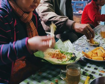 Midsection of woman eating food