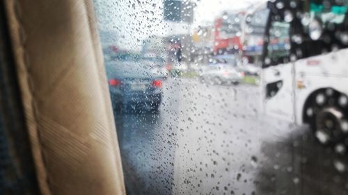 Close-up of wet car window in rainy season