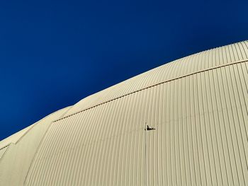 Low angle view of building against clear blue sky