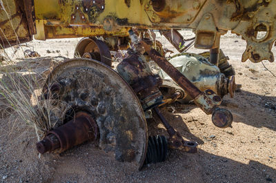 Axle of abandoned rusty vehicle in desert of angola, africa