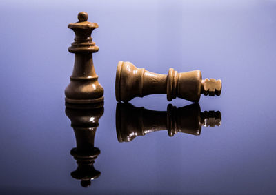 Close-up of chess pieces against blue background