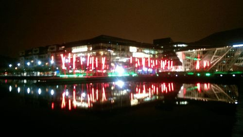 Reflection of illuminated built structure in water