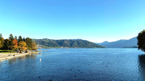 Scenic view of lake against clear blue sky