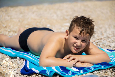 Midsection of man lying on beach