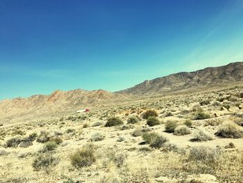 Scenic view of mountains against clear blue sky