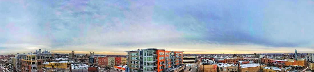 City buildings against cloudy sky