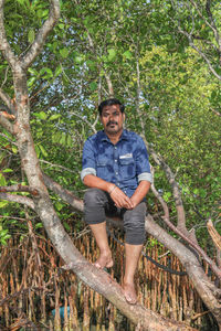 Portrait of man standing in forest