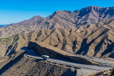 Scenic view of mountain range against blue sky