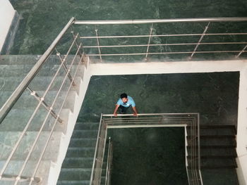 High angle view of man standing on staircase