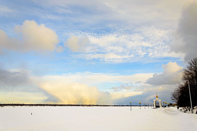 Snow covered land against sky