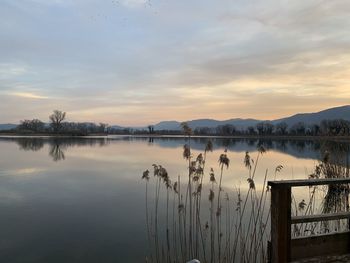 Scenic view of lake against sky during sunset