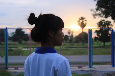 Close-up of woman against sky during sunset