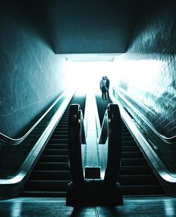 Rear view of man on escalator